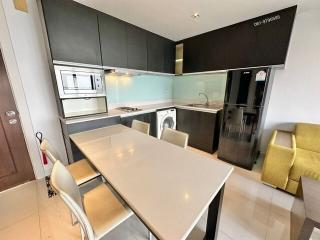 Modern kitchen with integrated appliances and dining area