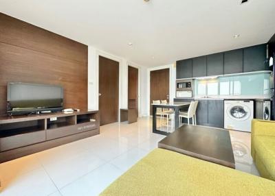 Modern open plan living room with integrated kitchen and stylish furnishings