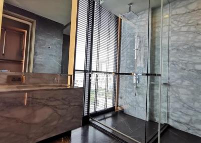 Modern bathroom with marble finishes and glass shower