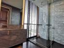 Modern bathroom with marble finishes and glass shower