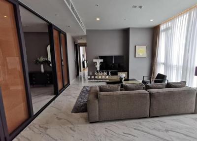 Spacious and modern living room with large windows and luxurious finishes