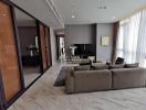 Spacious and modern living room with large windows and luxurious finishes