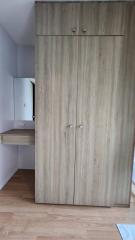 Compact bedroom with wooden wardrobe and study nook