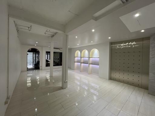 Spacious interior of a modern building with a motivational neon sign