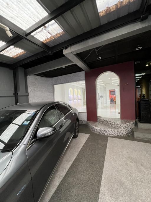 Modern garage interior with a car and access to the home