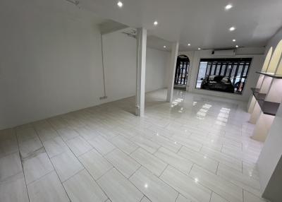 Spacious interior of a modern building with white tiled flooring and ample lighting