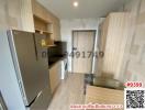 Compact modern kitchen with appliances and wood finish