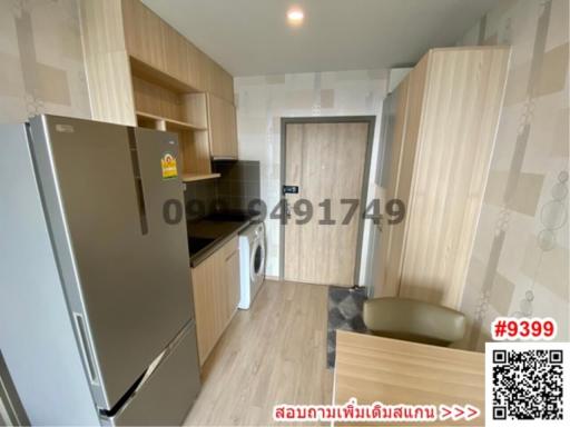 Compact modern kitchen with appliances and wood finish