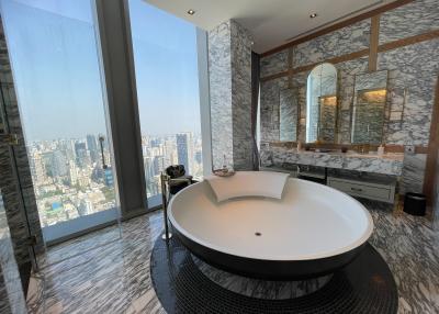 Luxurious bathroom with large bathtub and panoramic city view