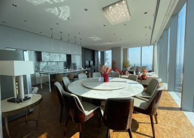 Modern high-rise apartment interior with open floor plan featuring living, dining, and kitchen