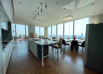 Spacious open-concept living area with kitchen, dining, and lounge spaces offering panoramic city views