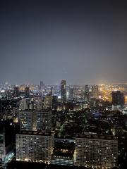 Aerial night view of a cityscape with illuminated buildings