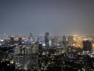 Aerial night view of a cityscape with illuminated buildings