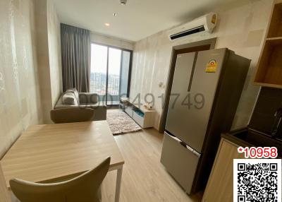 Modern furnished apartment interior with open-plan kitchen, living, and dining area