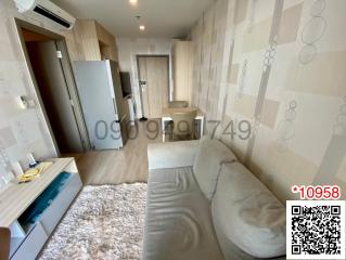 Modern living room interior with a comfortable grey sofa, TV unit, and wooden furniture