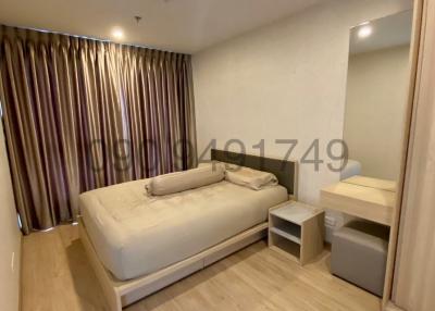 Modern furnished bedroom with laminated flooring