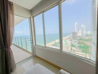 Bright bedroom with large windows and ocean view