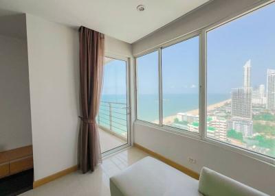 Bright bedroom with a large window overlooking the sea