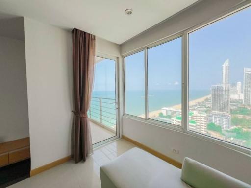 Bright bedroom with a large window overlooking the sea