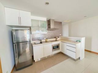 Modern kitchen with stainless steel appliances and mosaic backsplash