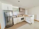 Modern kitchen with stainless steel appliances and mosaic backsplash