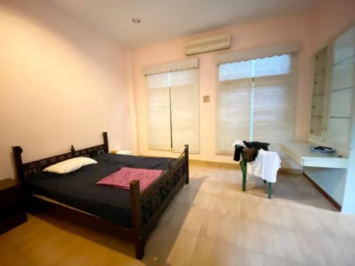Spacious bedroom with a large bed and modern flooring