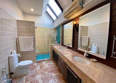 Spacious bathroom with natural light and modern amenities