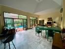 Spacious living room with high ceilings and pool view