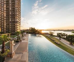 Luxurious infinity pool with a view of the sunset and high-rise apartments