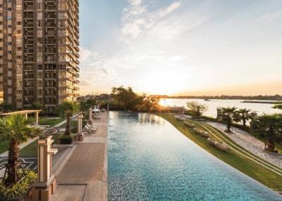 Luxurious infinity pool with a view of the sunset and high-rise apartments