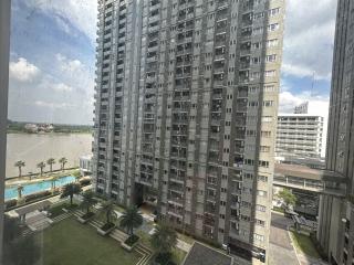 High-rise apartment building view with pool and garden area