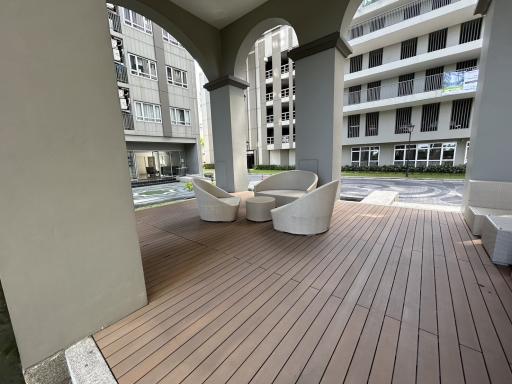 Modern building lobby with seating area and wooden flooring