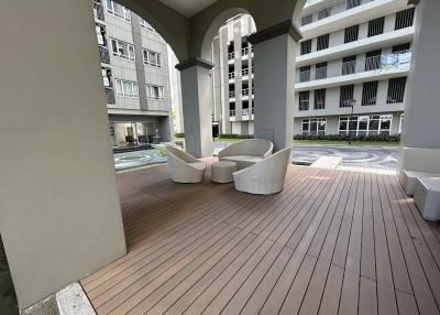 Modern building lobby with seating area and wooden flooring
