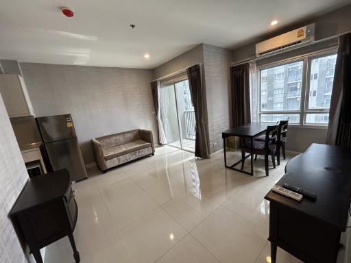 Spacious and well-lit living room with modern furniture and balcony access