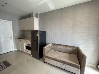 Modern kitchen with a couch and tiled flooring