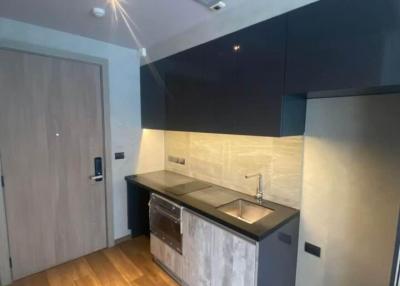 Modern kitchen with stainless steel appliances and wooden flooring