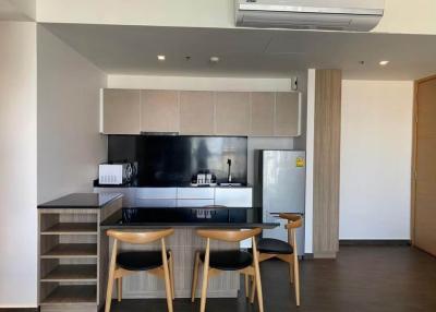 Modern kitchen with bar stools and wooden accents