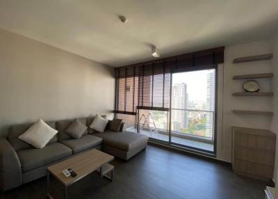 Cozy living room with a large window and city view