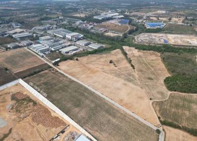 Aerial view of expansive undeveloped land near industrial area