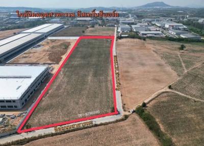 Aerial view of a large plot of land outlined in red, suitable for industrial or commercial development