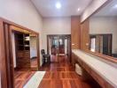 Spacious corridor inside house with hardwood floors and elegant wooden doors