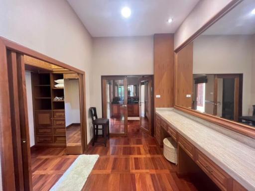 Spacious corridor inside house with hardwood floors and elegant wooden doors