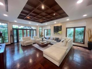 Spacious living room with hardwood floors and high ceiling