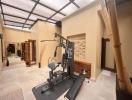 Spacious home gym with exercise equipment and natural light