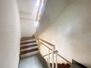 Interior staircase with white walls and handrail