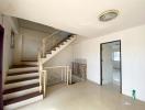 Interior view showing a staircase with railing and tiled flooring