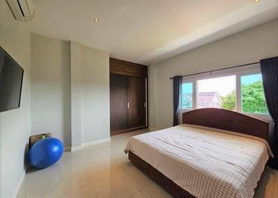 Spacious airy bedroom with large bed and modern amenities
