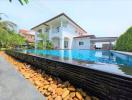 Spacious outdoor pool with a house in the background