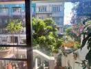 Cozy balcony overlooking greenery and neighboring buildings