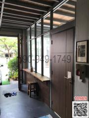 Spacious entryway with large windows and wooden accents